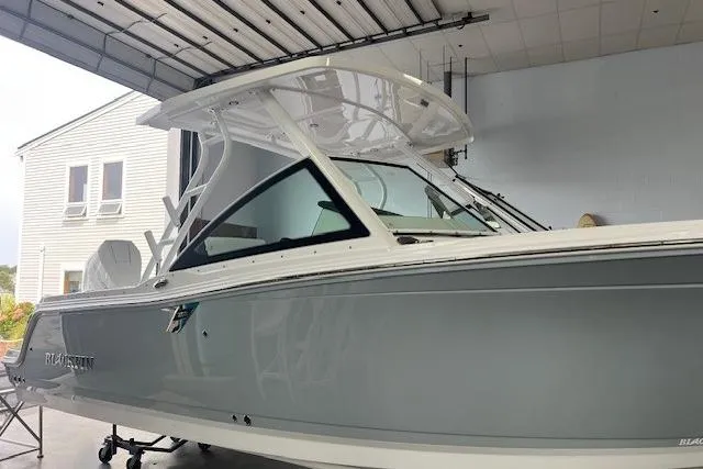 Slide: The Image of 2026 Blackfin 252 DC boat in a garage, showcasing sleek design and modern features. - 1