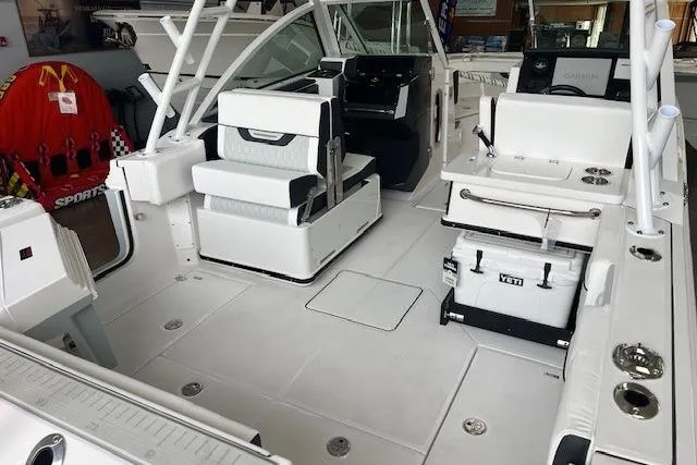 Slide: The Image of 2026 Blackfin 252 DC boat interior with seating, cooler, and fishing gear. - 15