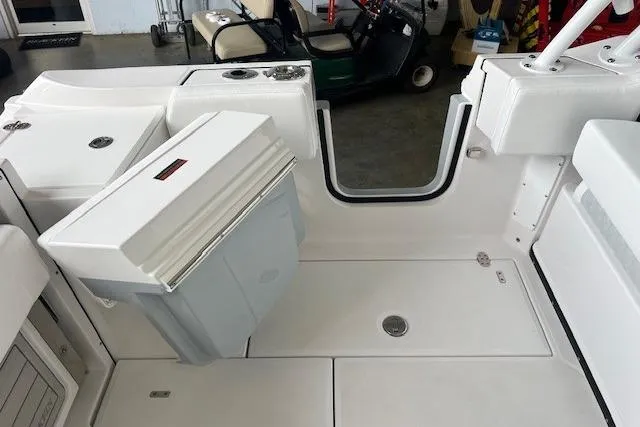 Slide: The Image of 2026 Blackfin 252 DC boat interior with white seating and storage compartments. - 2
