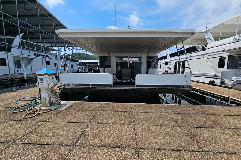 Slide: The Image of Houseboat docked at marina, Fantasy 18x80 model, 2001, with clear blue sky. - 1