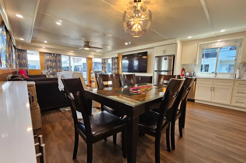 Slide: The Image of Spacious houseboat interior with dining area, modern kitchen, and cozy living space, Fantasy 18x80, 2001. - 11