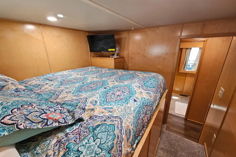 Slide: The Image of Cozy bedroom in 2001 Fantasy 18x80 houseboat with colorful bedding and TV. - 21