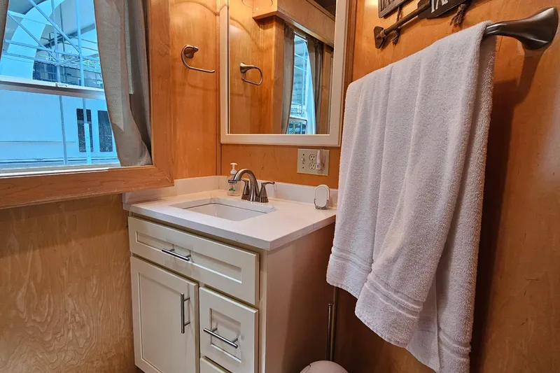 Slide: The Image of Compact bathroom with wooden walls, white sink, mirror, and towel in a Fantasy 18x80 model. - 26