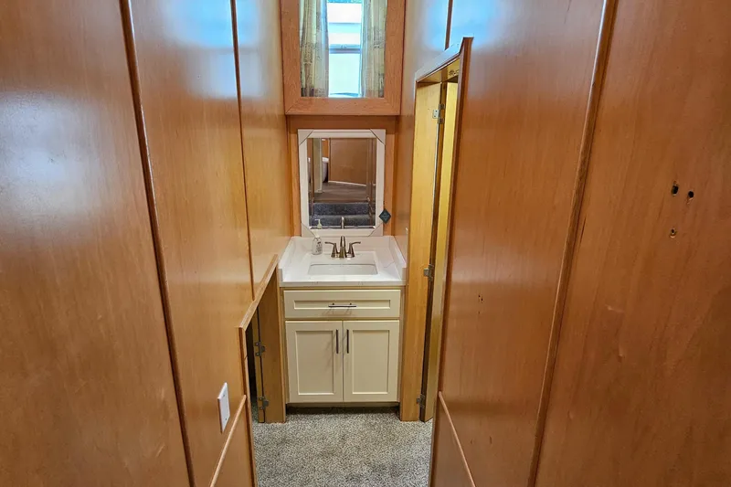 Slide: The Image of Narrow bathroom with wooden walls, white sink, and mirror in Fantasy 18x80 model. - 34
