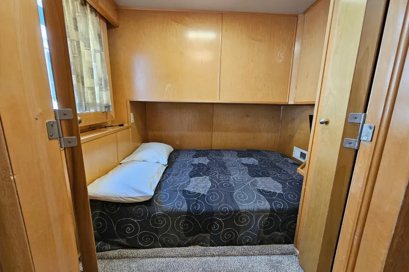 Slide: The Image of Cozy bedroom with wooden walls in a 2001 Fantasy 18x80 houseboat. - 39