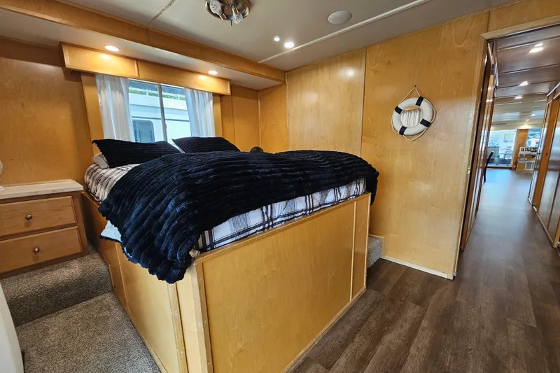 Slide: The Image of Cozy bedroom in a 2001 Fantasy 18x80 houseboat with wood paneling and nautical decor. - 47
