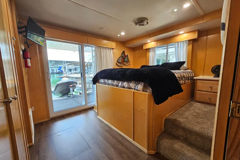 Slide: The Image of Cozy bedroom on a 2001 Fantasy 18x80 houseboat with modern amenities and marina view. - 48