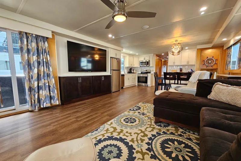 Slide: The Image of Luxurious houseboat interior with modern kitchen, large TV, and stylish decor, Fantasy 18x80 model. - 6