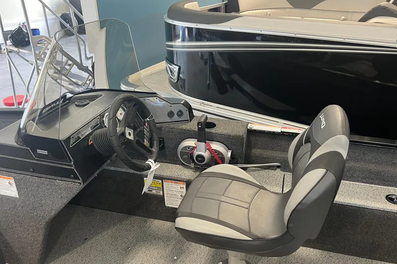 Slide: The Image of 2025 Lund 1650 Angler SS boat interior with steering wheel and seat. - 4
