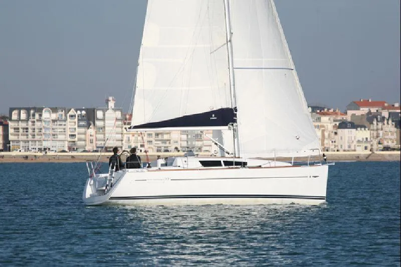 Slide: The Image of 2011 Jeanneau Sun Odyssey 33i sailing near coastal buildings. - 0