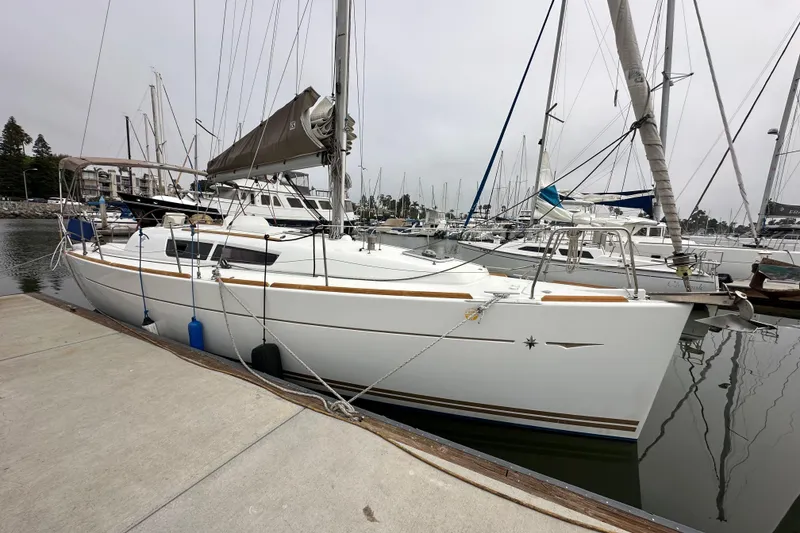 Slide: The Image of Sailboat Jeanneau Sun Odyssey 33i, 2011 model, docked at marina with other boats. - 17