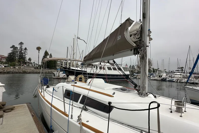 Slide: The Image of 2011 Jeanneau Sun Odyssey 33i sailboat docked in a marina, overcast sky. - 18