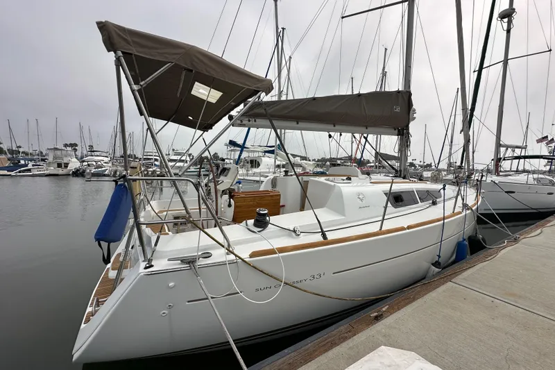 Slide: The Image of 2011 Jeanneau Sun Odyssey 33i sailboat docked in marina, overcast sky. - 20