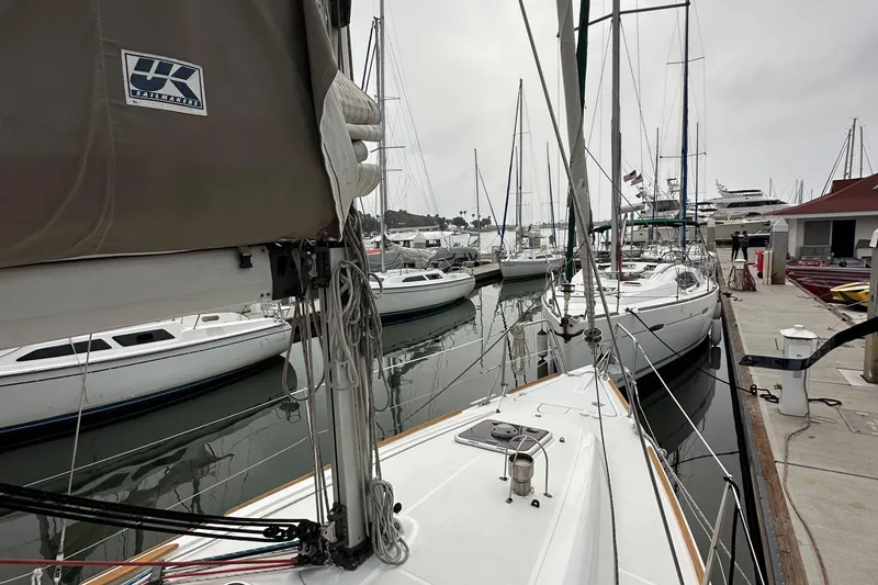 Slide: The Image of 2011 Jeanneau Sun Odyssey 33i sailboat docked at marina with other boats. - 23