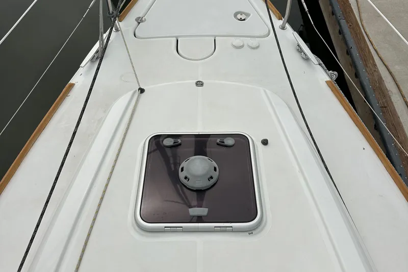 Slide: The Image of Deck view of 2011 Jeanneau Sun Odyssey 33i sailboat, featuring a hatch and clean lines. - 24