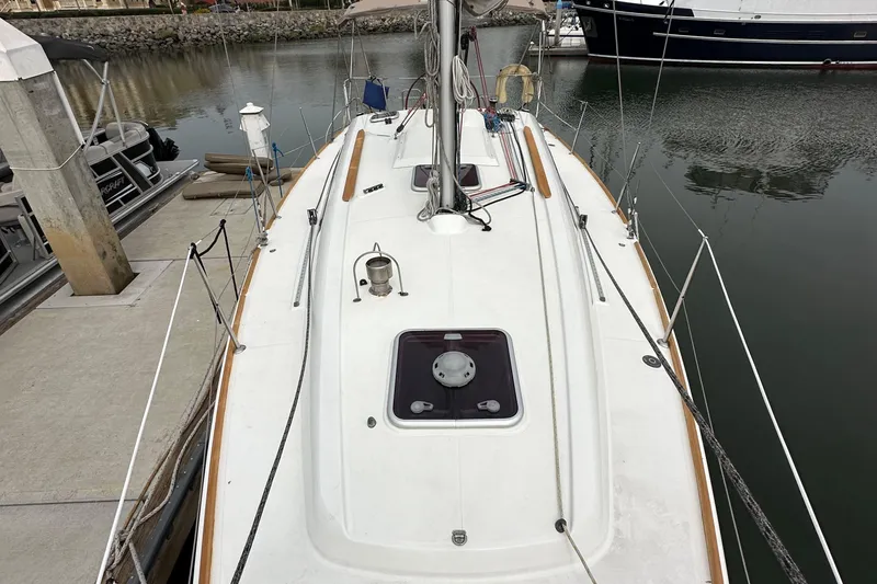 Slide: The Image of 2011 Jeanneau Sun Odyssey 33i sailboat docked at marina, view of deck and mast. - 27