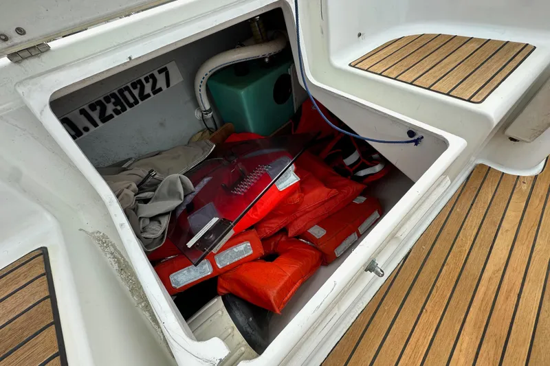 Slide: The Image of Storage compartment on a 2011 Jeanneau Sun Odyssey 33i with life jackets and equipment. - 37