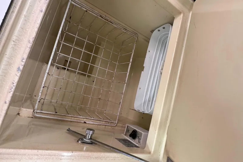 Slide: The Image of Interior of a 2011 Jeanneau Sun Odyssey 33i boat compartment with metal grid. - 43