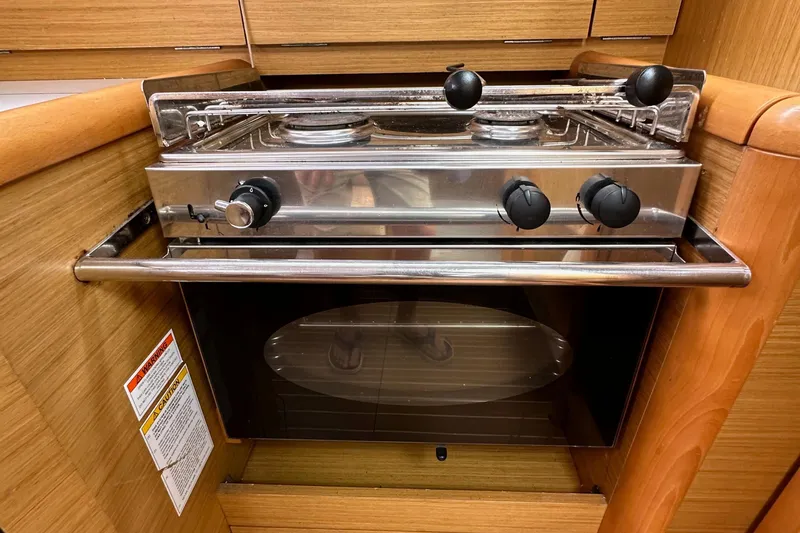 Slide: The Image of Stainless steel stove and oven in Jeanneau Sun Odyssey 33i yacht kitchen, 2011 model. - 44