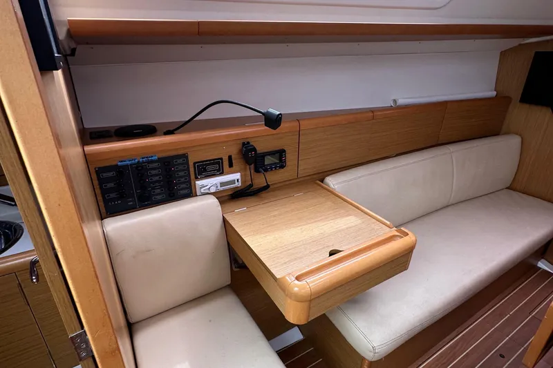 Slide: The Image of Interior of 2011 Jeanneau Sun Odyssey 33i yacht with navigation station and seating area. - 47