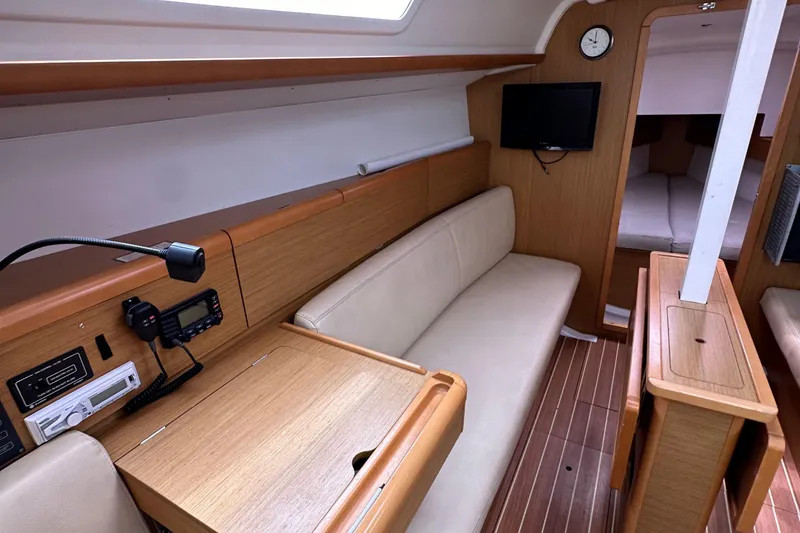 Slide: The Image of Interior of 2011 Jeanneau Sun Odyssey 33i sailboat with cozy seating and navigation equipment. - 49