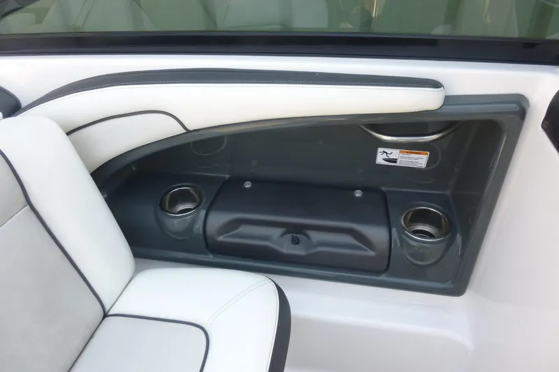 Slide: The Image of Interior of 2014 Yamaha Boats 240, featuring white seating and cup holders. - 10