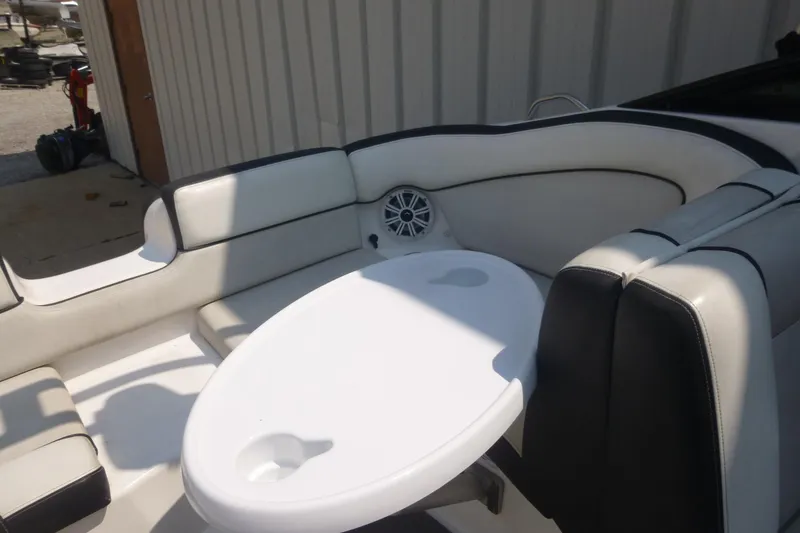 Slide: The Image of 2014 Yamaha Boats 240 interior with white seating and oval table. - 13
