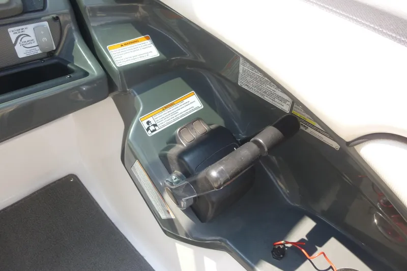 Slide: The Image of Control panel of a 2014 Yamaha Boats 240, featuring throttle and warning labels. - 16