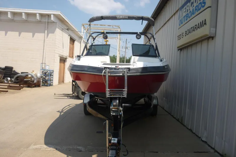 Slide: The Image of 2014 Yamaha Boats 240 on trailer at Ted's Boatarama, parked outside. - 2