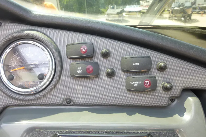Slide: The Image of Dashboard controls of a 2014 Yamaha Boats 240, featuring switches and a gauge. - 8