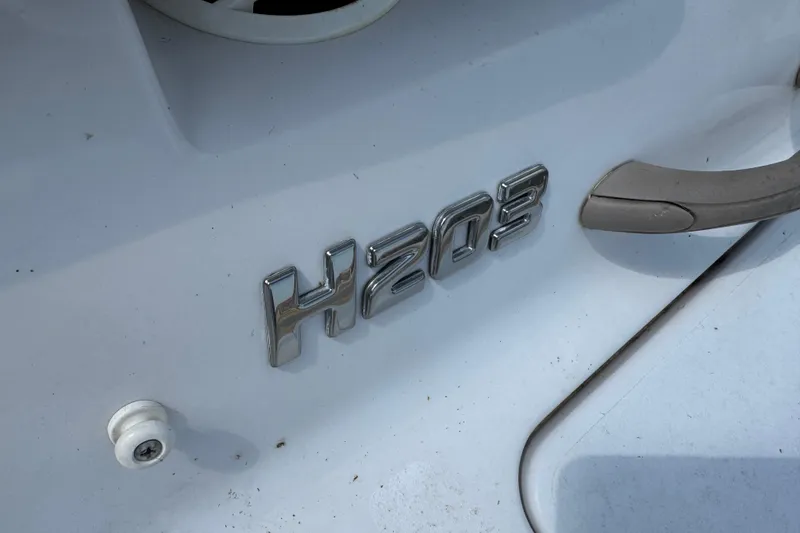 Slide: The Image of 2008 Four Winns H203 boat emblem on white surface. - 10