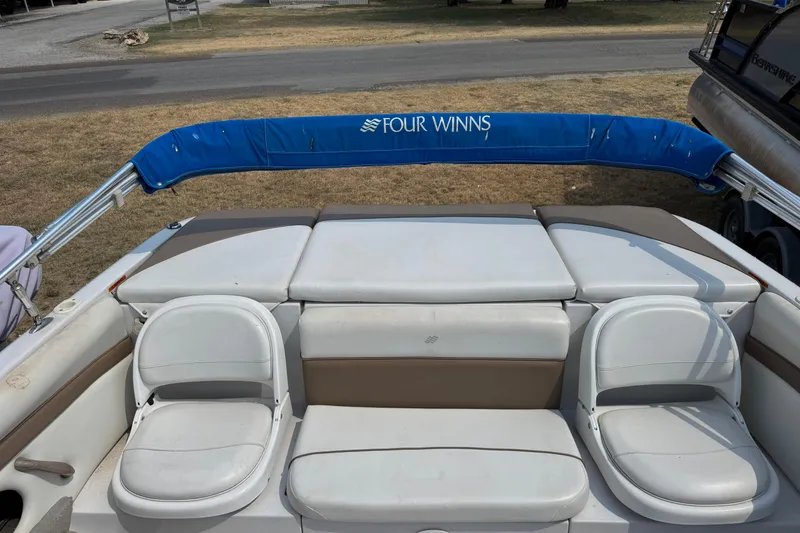Slide: The Image of 2008 Four Winns H203 boat interior with white seating and blue canopy. - 11