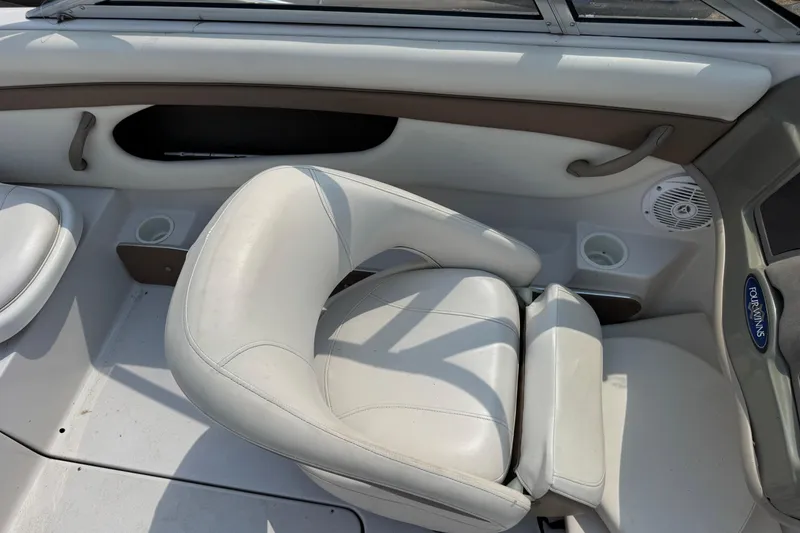 Slide: The Image of 2008 Four Winns H203 boat interior with white seating and cup holders. - 12