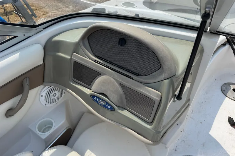 Slide: The Image of Interior of 2008 Four Winns H203 boat showing dashboard and speaker system. - 13