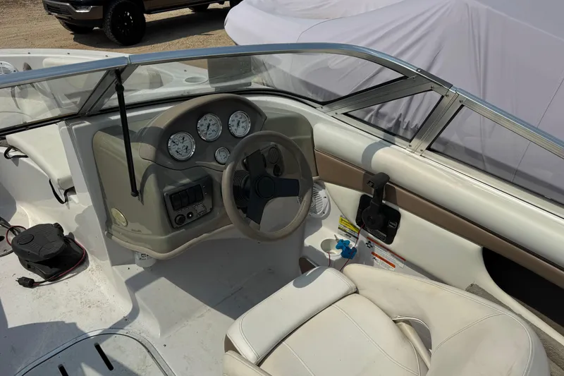Slide: The Image of 2008 Four Winns H203 boat cockpit with steering wheel and dashboard gauges. - 14
