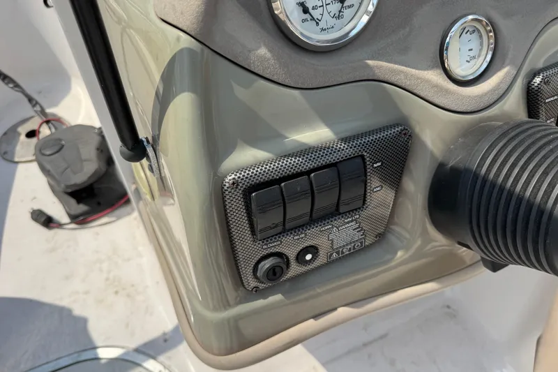 Slide: The Image of Dashboard controls of a 2008 Four Winns H203 boat, featuring switches and gauges. - 16