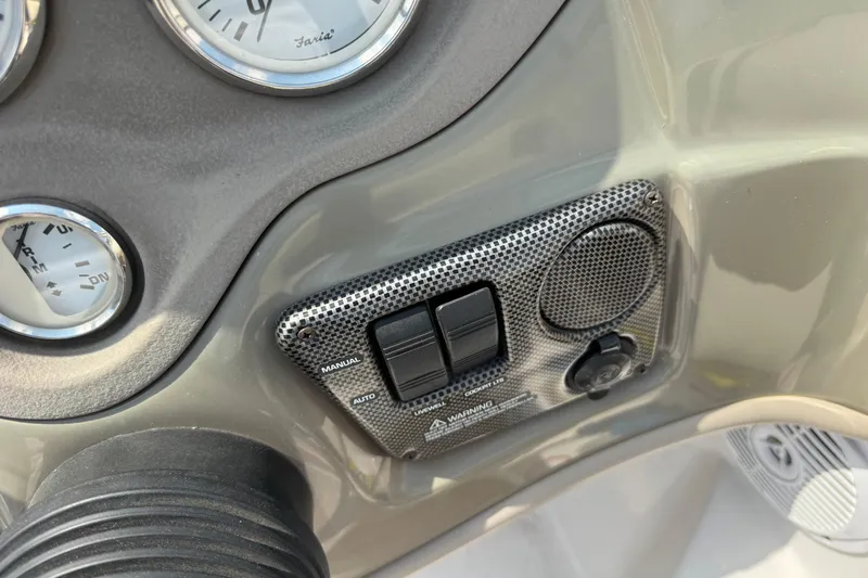 Slide: The Image of Dashboard controls of a 2008 Four Winns H203 boat, featuring gauges and switches. - 18