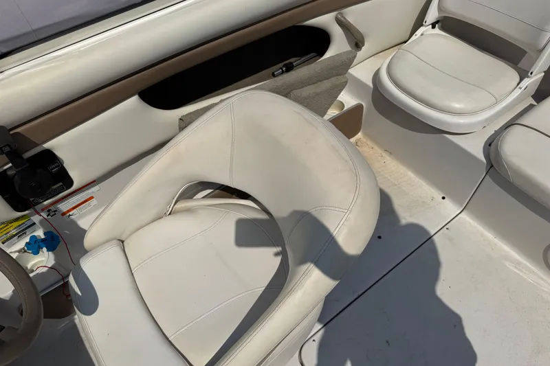 Slide: The Image of Interior of 2008 Four Winns H203 boat with white seating and steering area. - 19