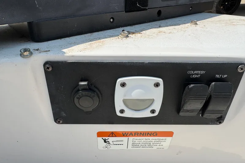 Slide: The Image of Control panel of a 2008 Four Winns H203 boat with warning label and switches. - 22