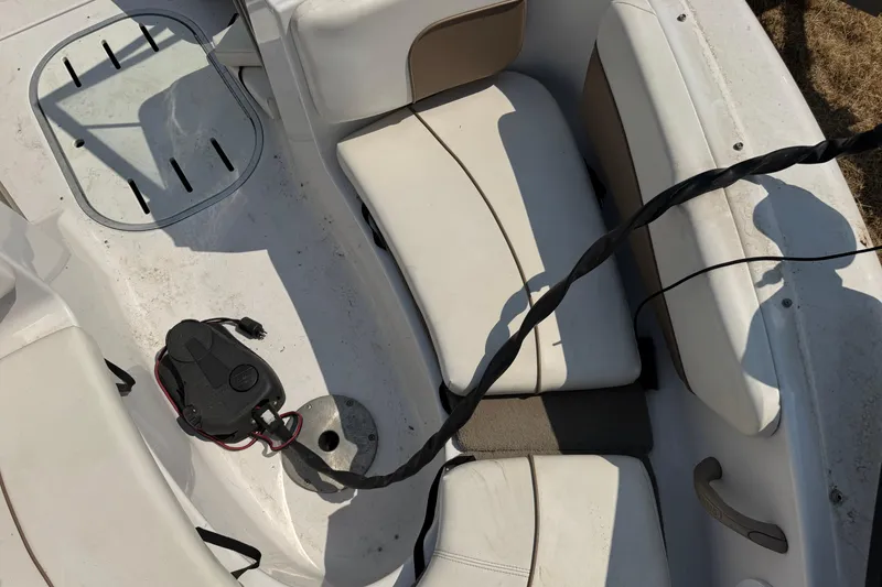 Slide: The Image of Interior of a 2008 Four Winns H203 boat with white seating and electrical components. - 24