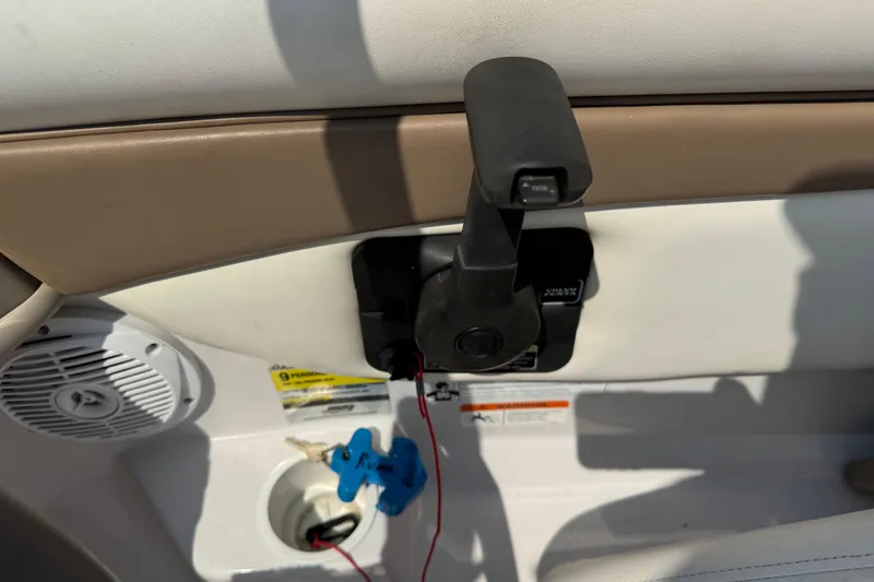 Slide: The Image of Interior of a 2008 Four Winns H203 boat showing throttle control and speaker. - 25