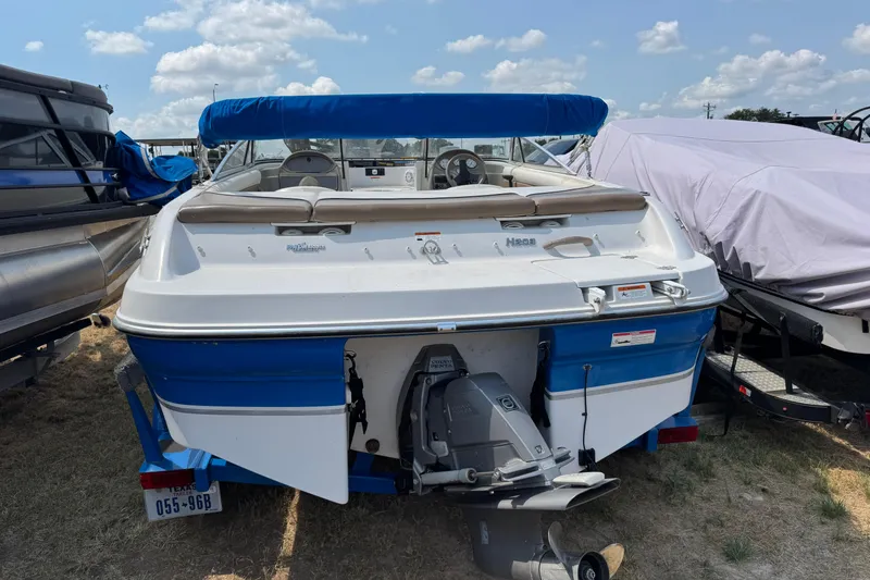 Slide: The Image of 2008 Four Winns H203 boat with blue and white exterior, parked on a trailer. - 3