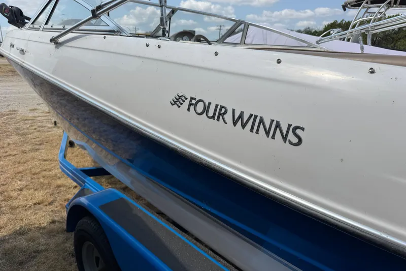 Slide: The Image of 2008 Four Winns H203 boat on a blue trailer, side view. - 4