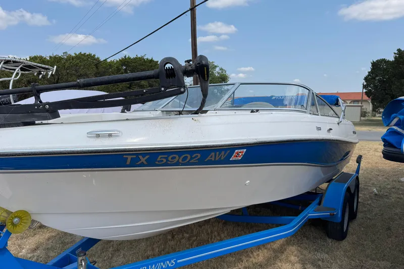 Slide: The Image of 2008 Four Winns H203 boat on trailer, white and blue, parked outdoors. - 5