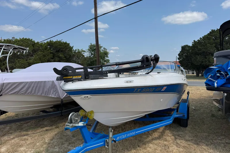 Slide: The Image of 2008 Four Winns H203 boat on trailer, parked outdoors under a clear sky. - 6