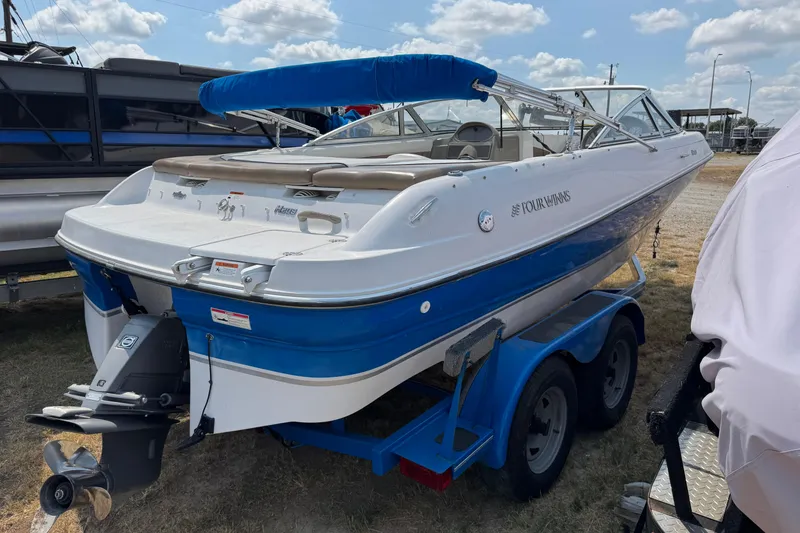Slide: The Image of 2008 Four Winns H203 boat on trailer, blue and white design, outdoor setting. - 7