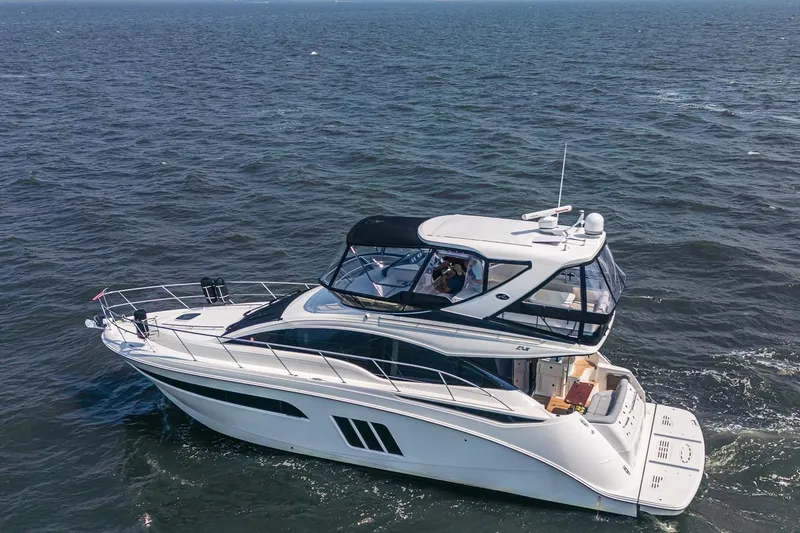 Slide: The Image of 2017 Sea Ray Fly 510 yacht cruising on open water. - 11