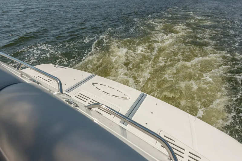 Slide: The Image of 2017 Sea Ray Fly 510 yacht cruising on open water, view from the deck. - 13