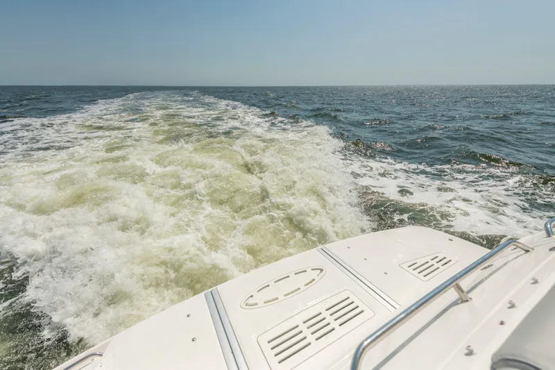 Slide: The Image of 2017 Sea Ray Fly 510 cruising, leaving a wake on open water. - 14