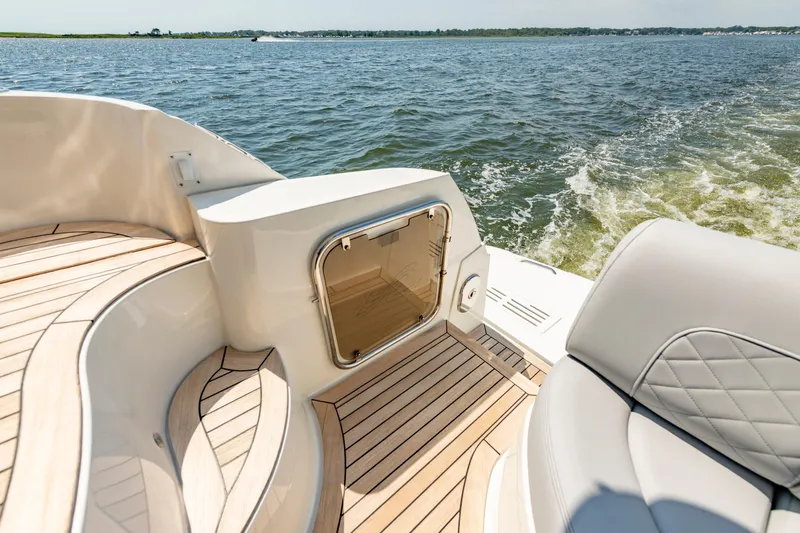 Slide: The Image of Luxurious 2017 Sea Ray Fly 510 yacht deck with elegant wood finish, cruising on open water. - 19